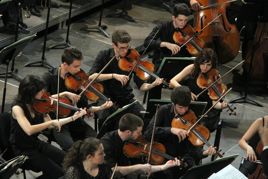 Conjunto de violinistas interpretando una obra musical
